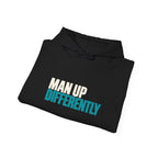 Folded black MUD Essential Hoodie showing Man Up Differently text