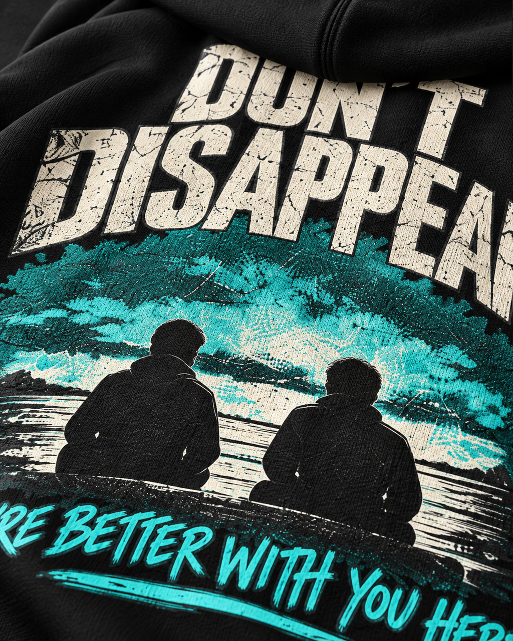 Close-up of black MUD STAY zip hoodie back print with Don’t Disappear message and teal graphic