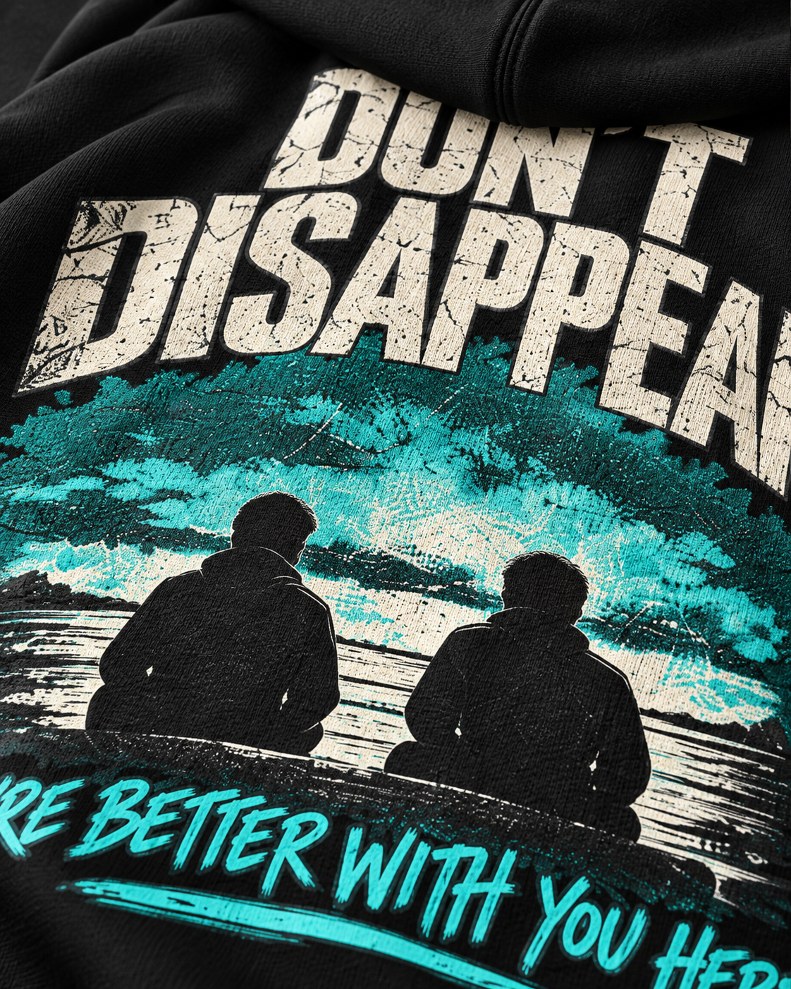 Close-up of black MUD STAY zip hoodie back print with Don’t Disappear message and teal graphic
