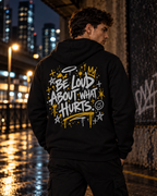 Black BE LOUD Hoodie back with Be Loud About What Hurts graphic