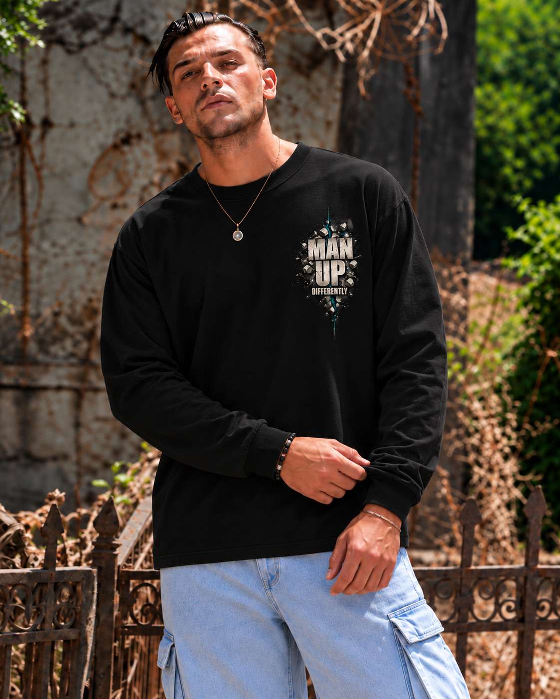 Model wearing black MUD BREAK THROUGH Long Sleeve, front view with small Man Up Differently chest graphic