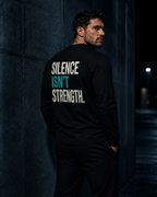 Model wearing MUD Essential Long Sleeve back view with Silence Isn't Strength graphic