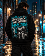 Model wearing MUD After Dark Hoodie back view with When The Days Get Darker Speak Louder graphic
