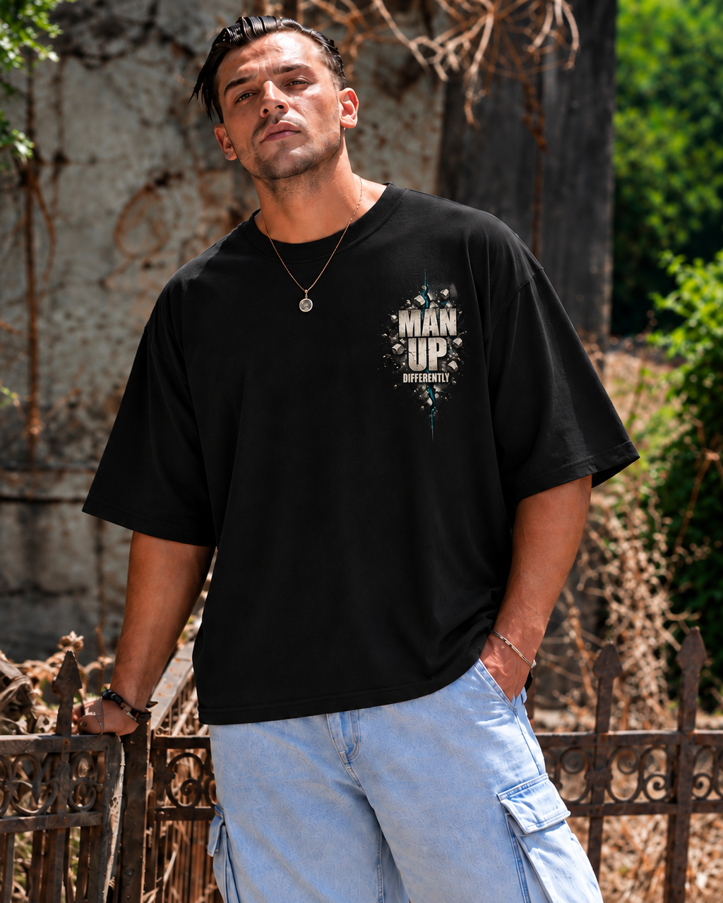 Model wearing black MUD BREAK THROUGH Tee, front view with small Man Up Differently chest graphic