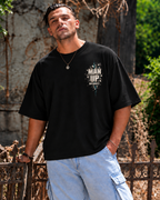 Model wearing black MUD BREAK THROUGH Tee, front view with small Man Up Differently chest graphic